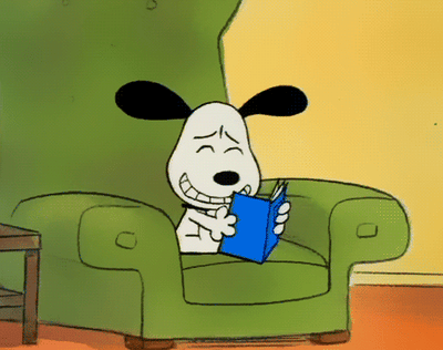 snoopy laughing reading a book