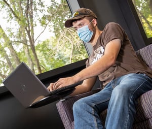 Concourse - male on computer with mask B