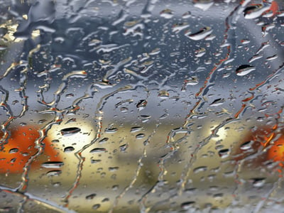 Rainy windshield (shallow depth of field) in morning rush hour