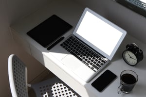 blank screen laptop computer and smart phone and digital tablet and stylus pen is on wooden desk as workplace concept